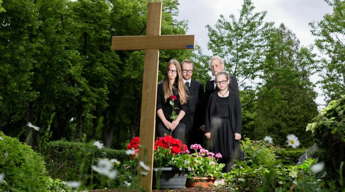 A Family Posing In Front Of A Cross, Navigating Grief And Remembering Love