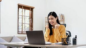 Asian Woman Working On A Laptop At Home.
