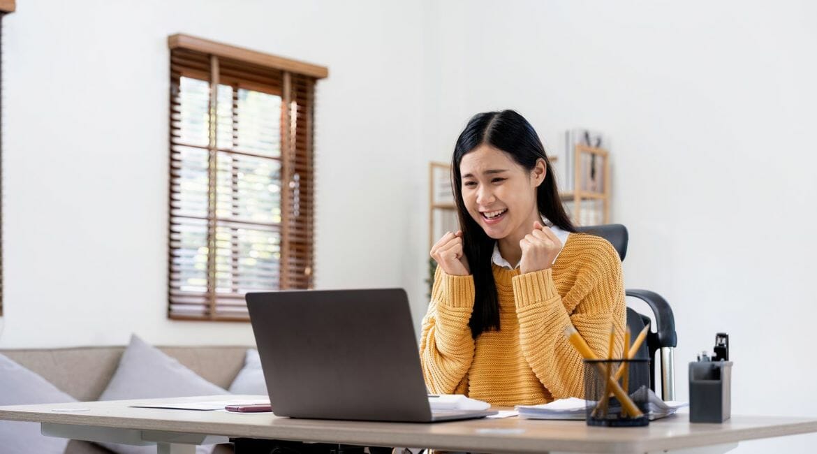 Asian Woman Working On A Laptop At Home.